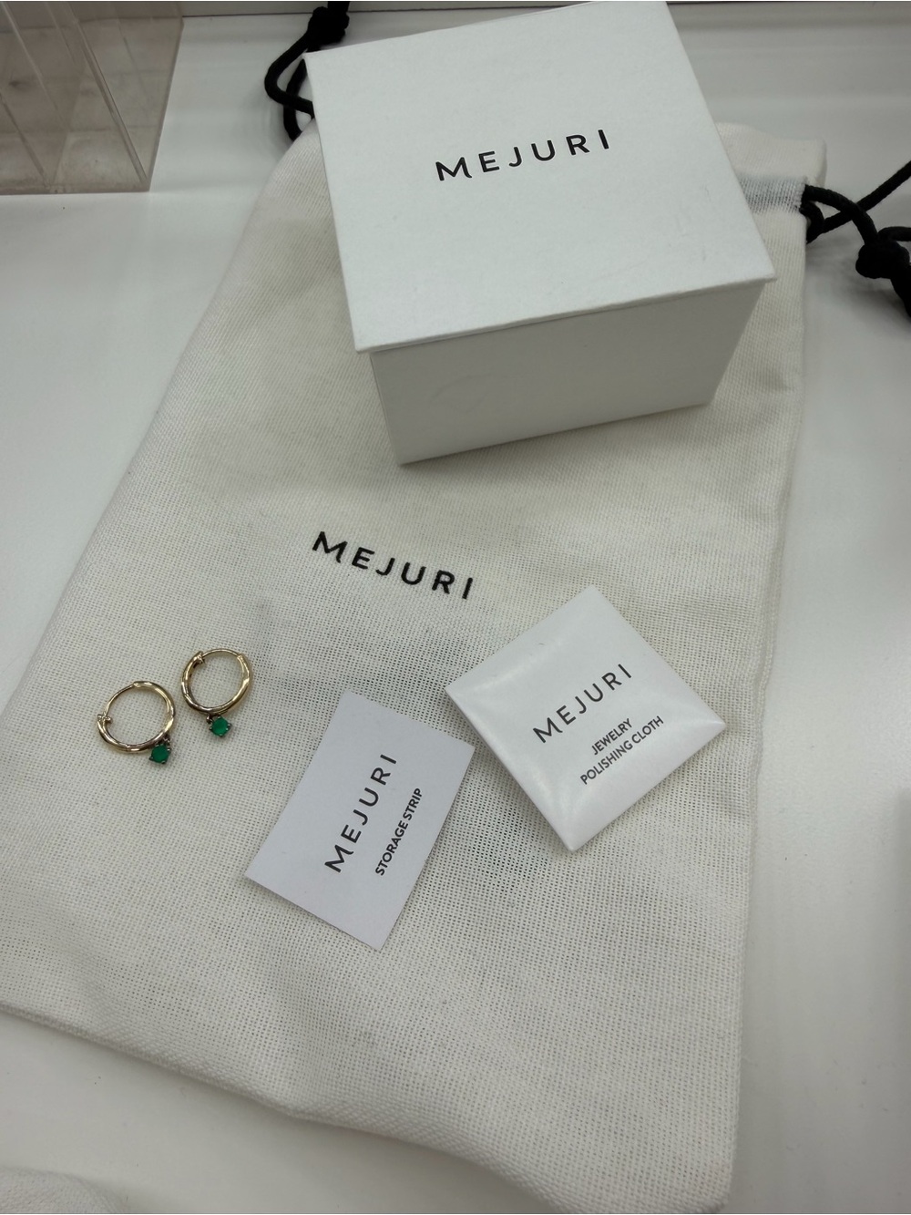Mejuri Gold Huggie Earrings with Emerald-Green Stones